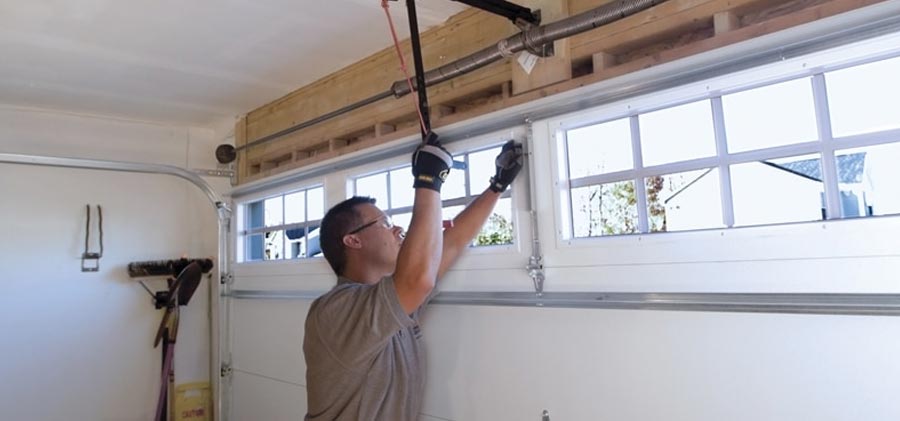 Garage door spring being repaired by a professional